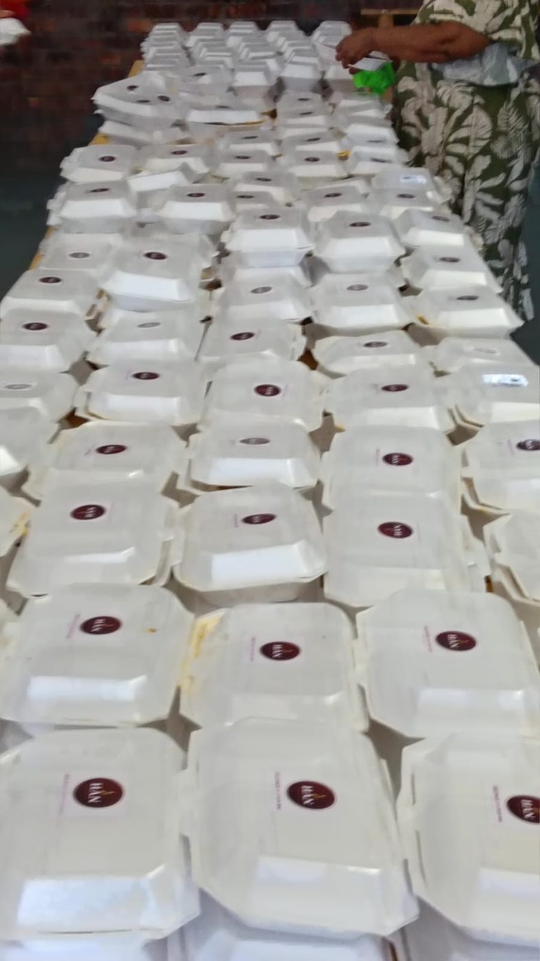 Rows of meal containers, each marked with the HelpAge Nation emblem