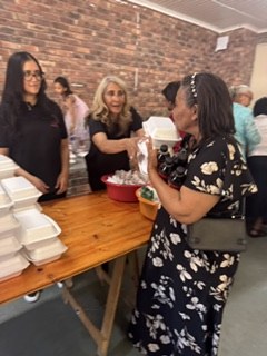 A team member handing a meal to a guest