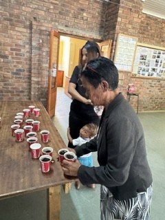A guest collecting a cup at the drinks table